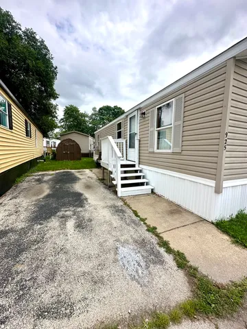 a view of a house with backyard and sitting area