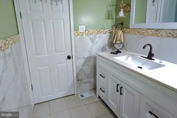 a bathroom with a double vanity sink and mirror