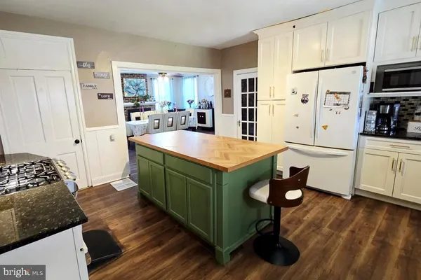 a kitchen with stainless steel appliances granite countertop a refrigerator and a stove top oven
