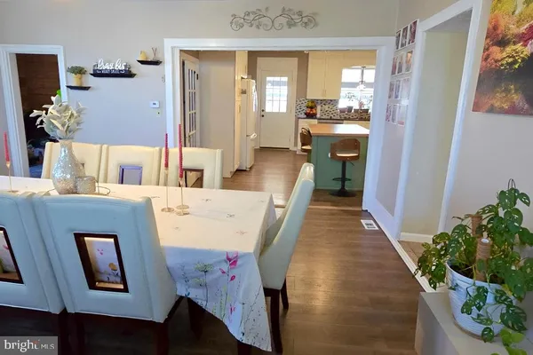 a dining room with furniture and wooden floor