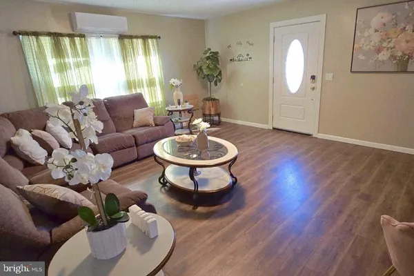 a living room with furniture a window and a potted plant