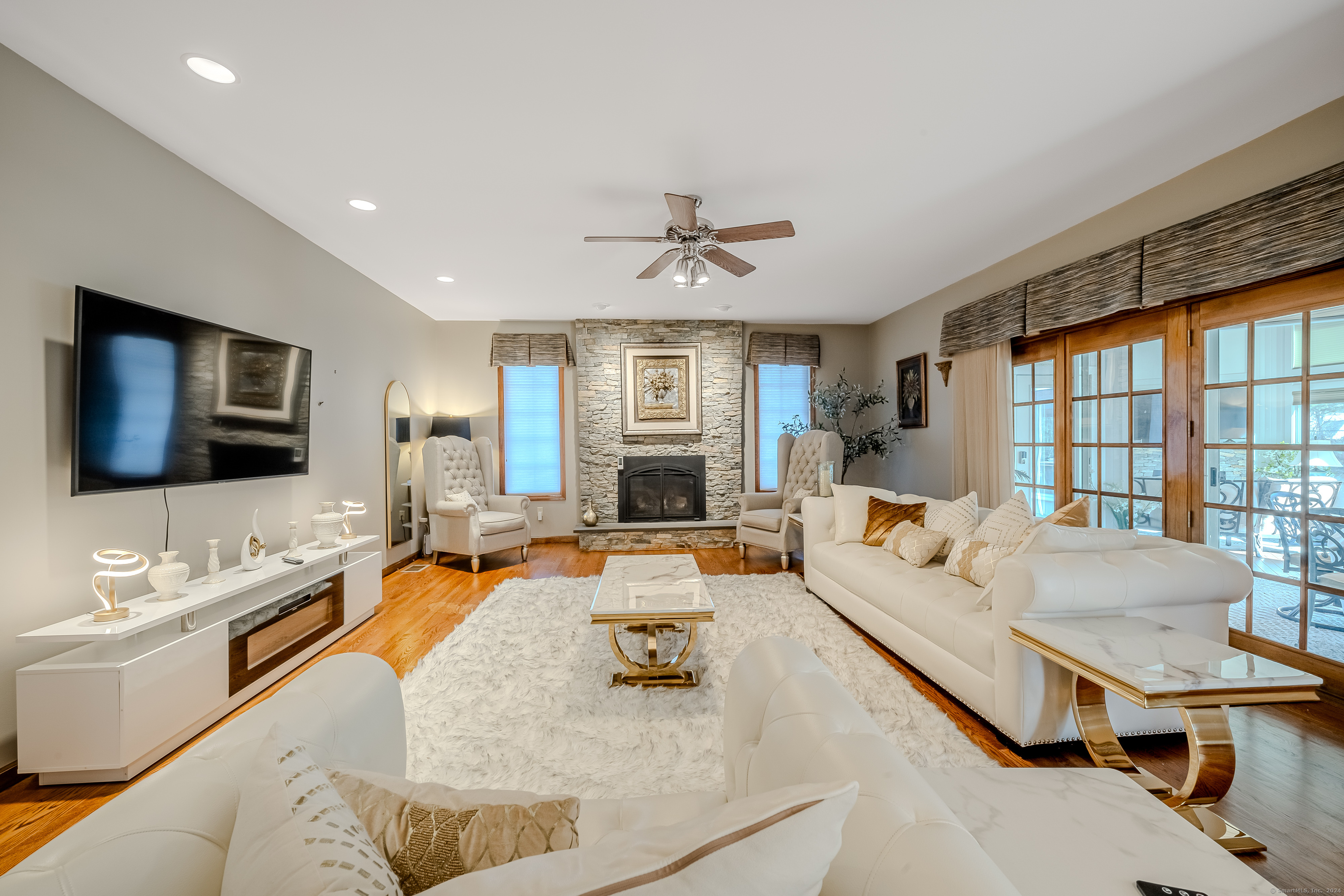 723 Laurie Lane Orange, CT 06477 - Photo 14 of 39 a living room with furniture and a flat screen tv