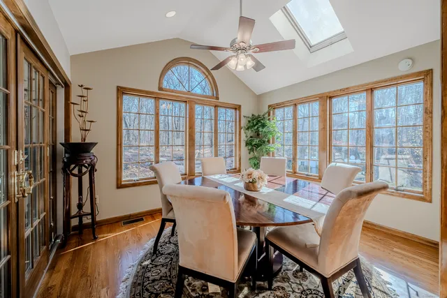 a dining room with furniture a chandelier and wooden floor