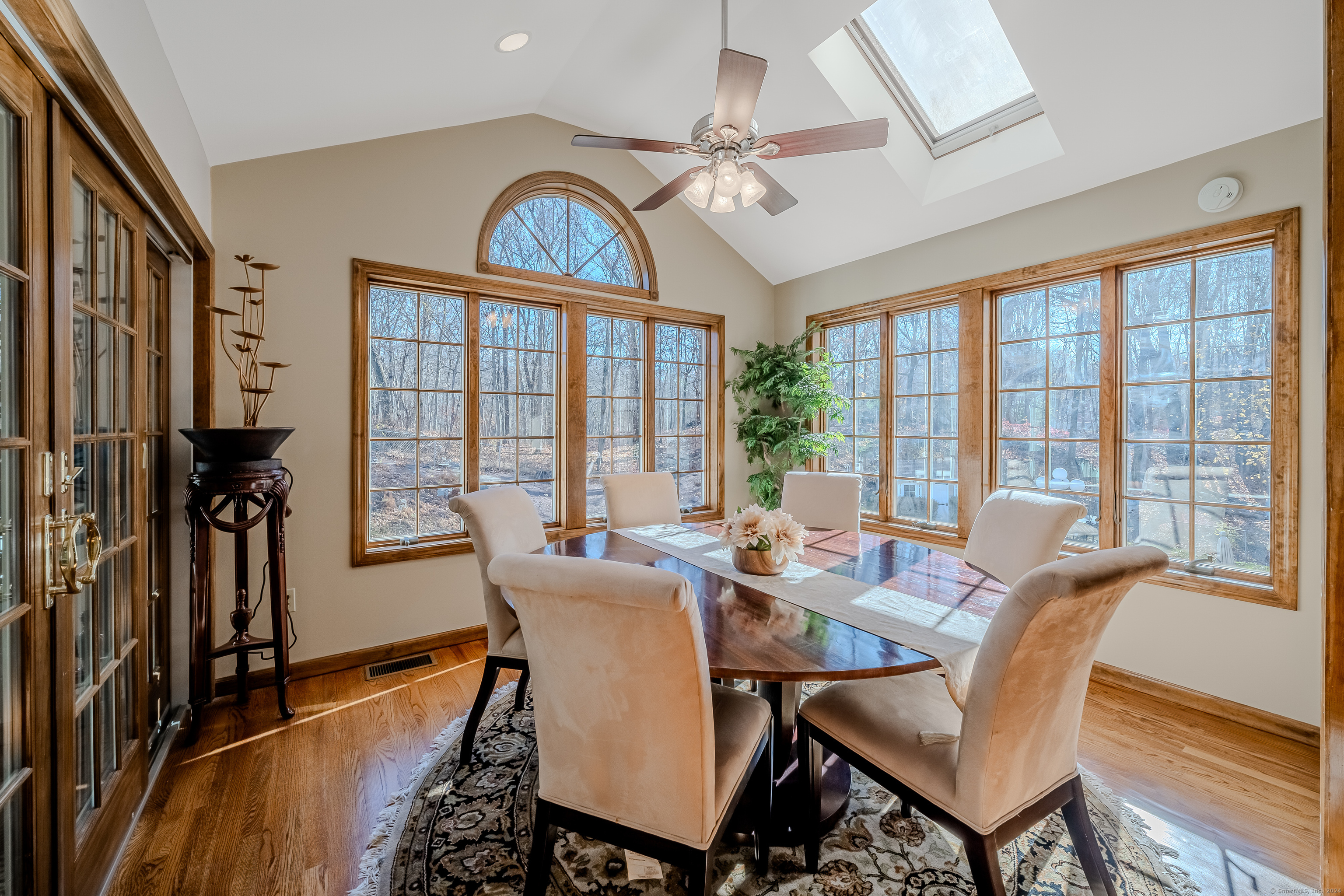723 Laurie Lane Orange, CT 06477 - Photo 15 of 39 a dining room with furniture a chandelier and wooden floor