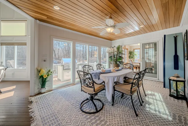 a dining room with furniture window and wooden floor