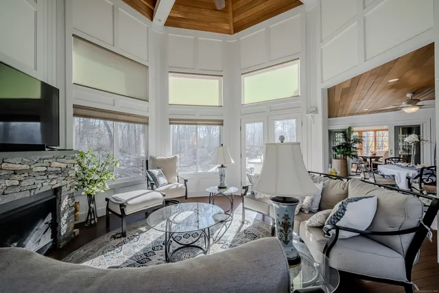 a living room with furniture fireplace and flat screen tv