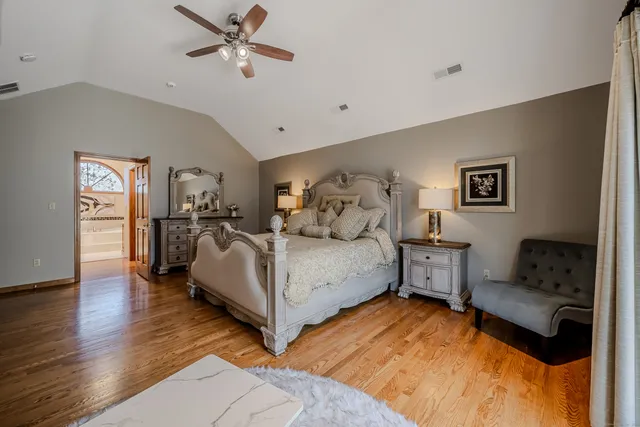 a bedroom with furniture and a wooden floor