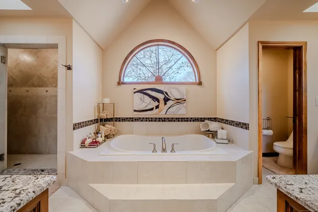 a bathroom with a tub and a window