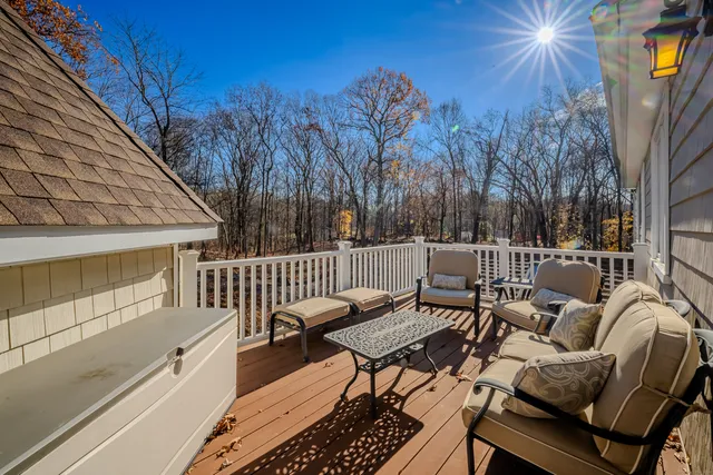 a view of a chairs and table on the roof deck