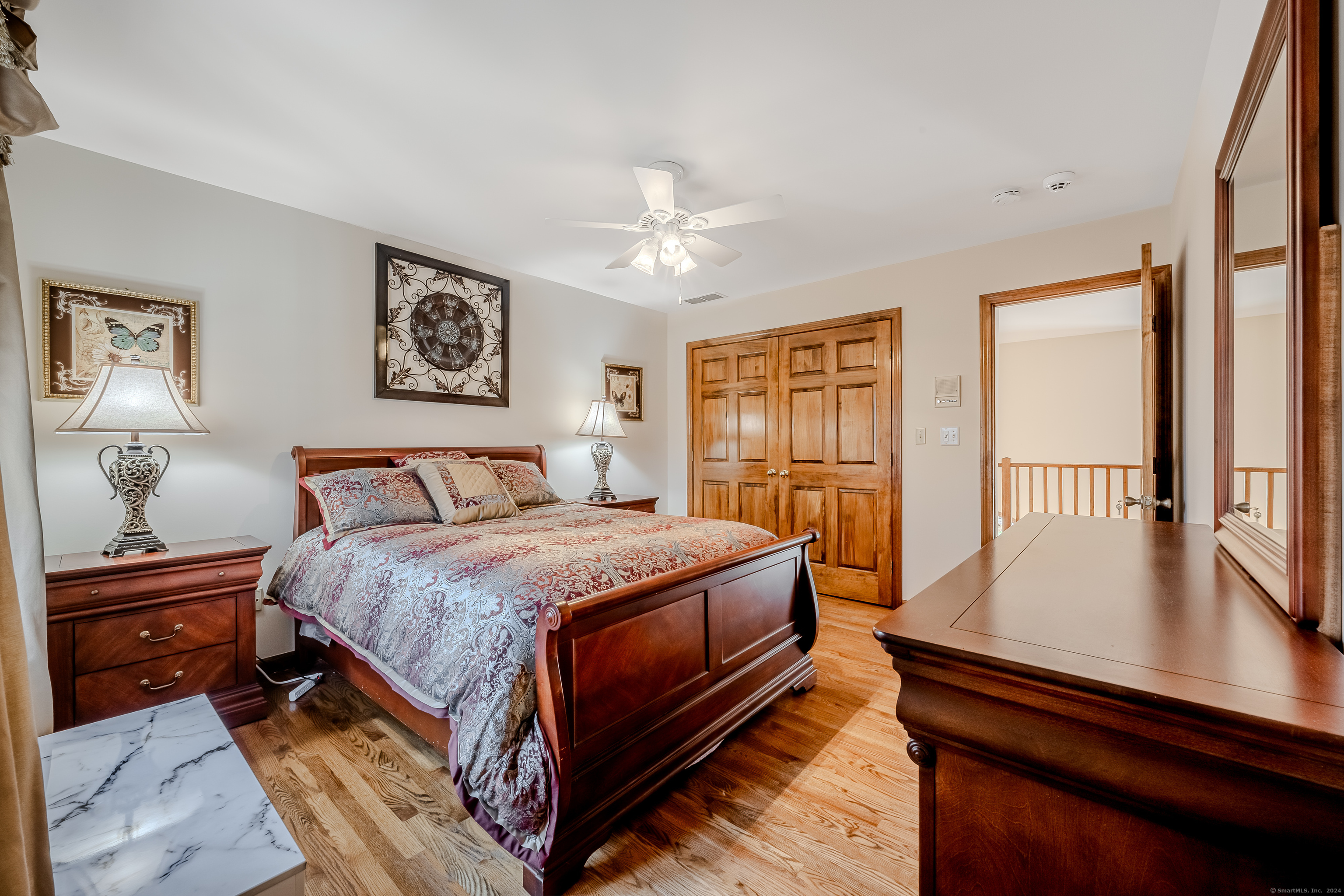 723 Laurie Lane Orange, CT 06477 - Photo 27 of 39 a bedroom with bed and wooden floor