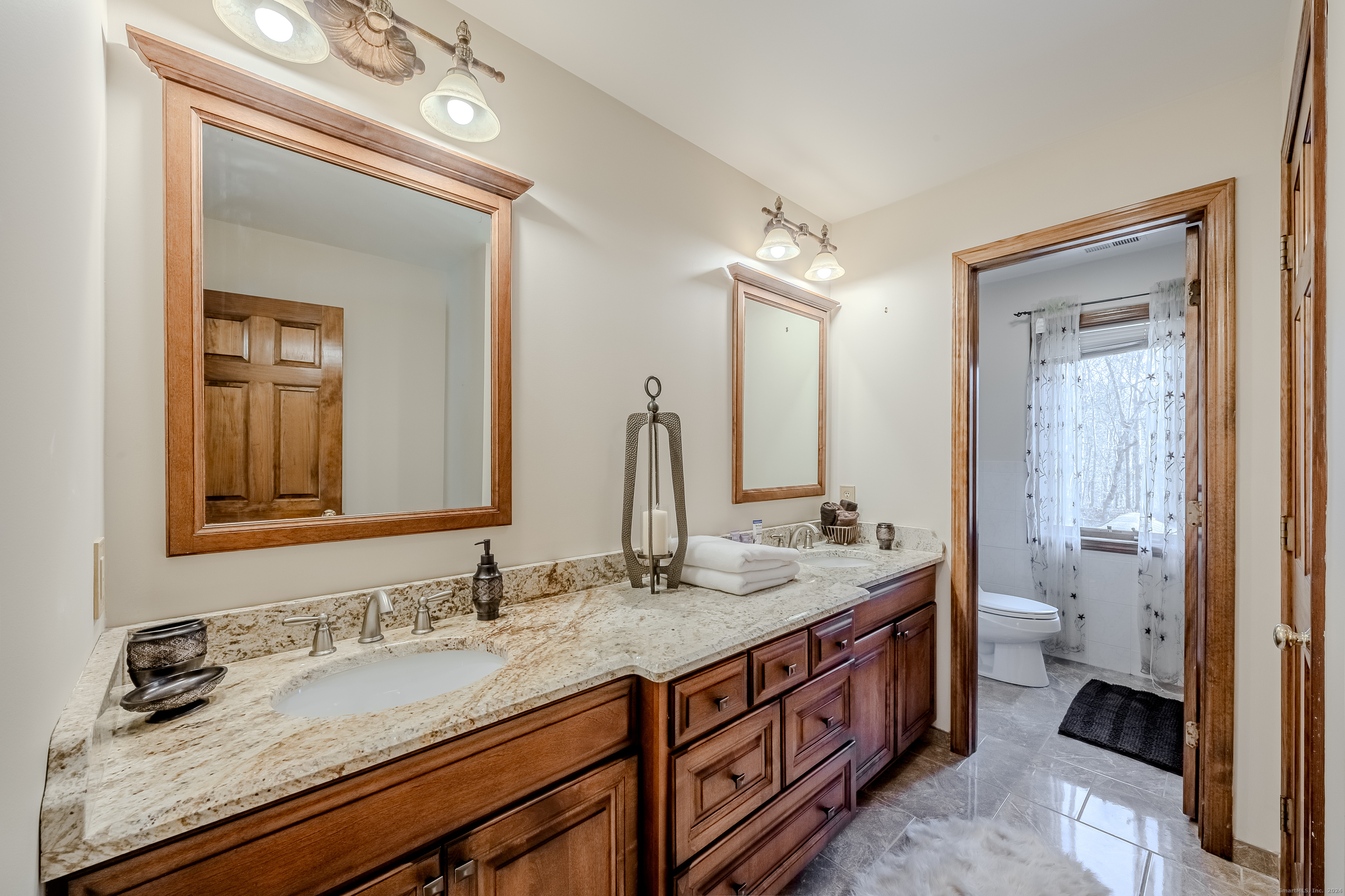 723 Laurie Lane Orange, CT 06477 - Photo 28 of 39 a bathroom with a double vanity sink and a mirror