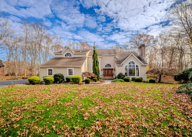 a view of a white house with a yard