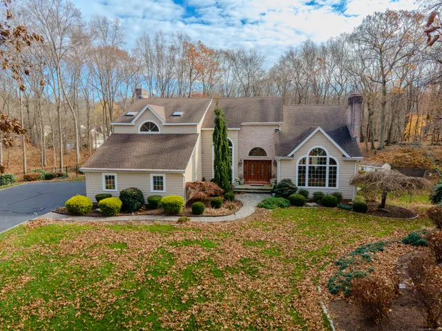 a front view of house with yard and green space