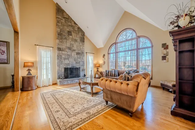 a living room with furniture fireplace and wooden floor