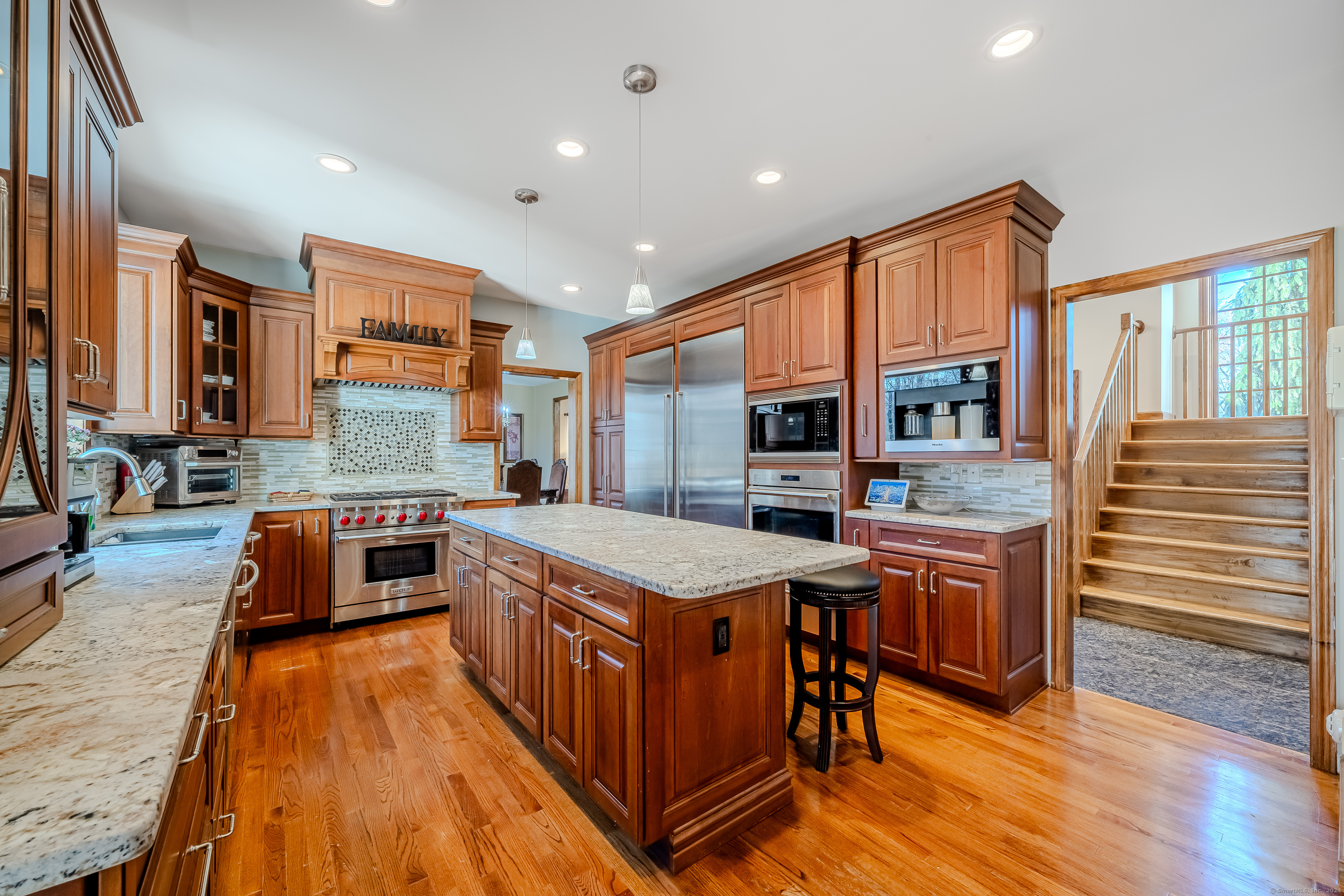 723 Laurie Lane Orange, CT 06477 - Photo 9 of 39 a kitchen with stainless steel appliances granite countertop a stove and a sink