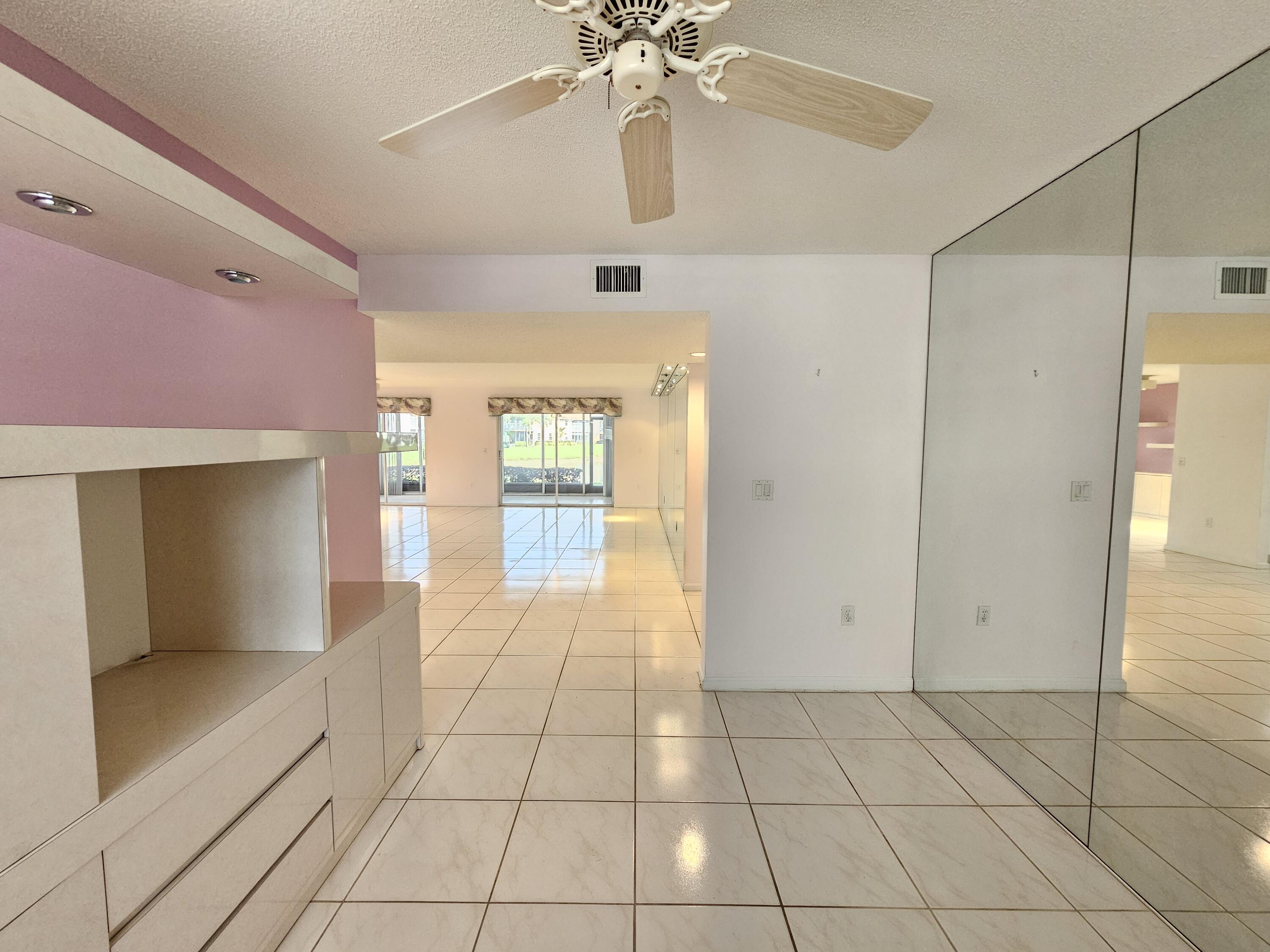 9963 Seacrest Circle, Unit 101 Boynton Beach, FL 33437 - Photo 13 of 27 a view of an entryway with a chandelier fan