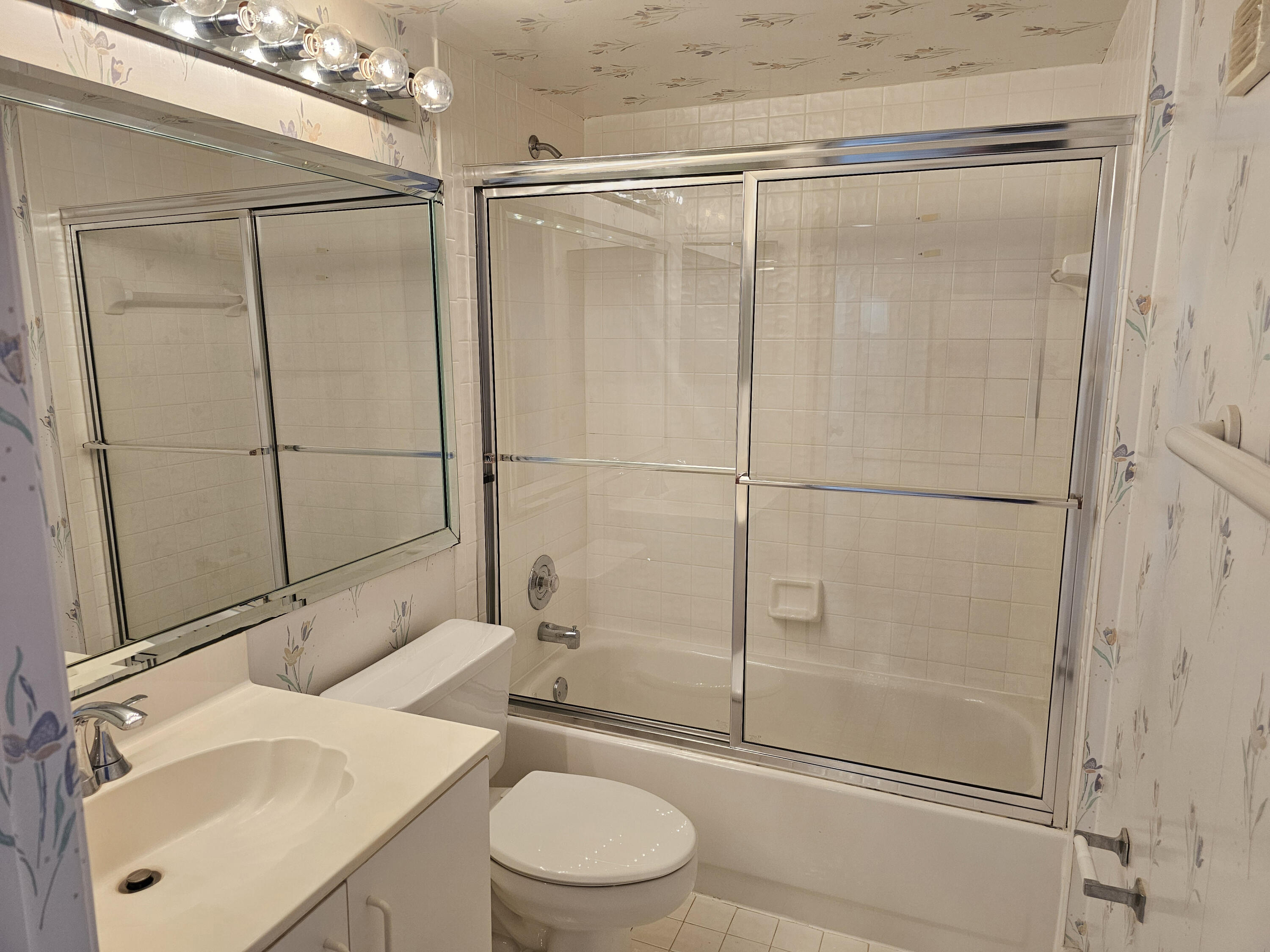 9963 Seacrest Circle, Unit 101 Boynton Beach, FL 33437 - Photo 21 of 27 a bathroom with a granite countertop sink toilet and shower