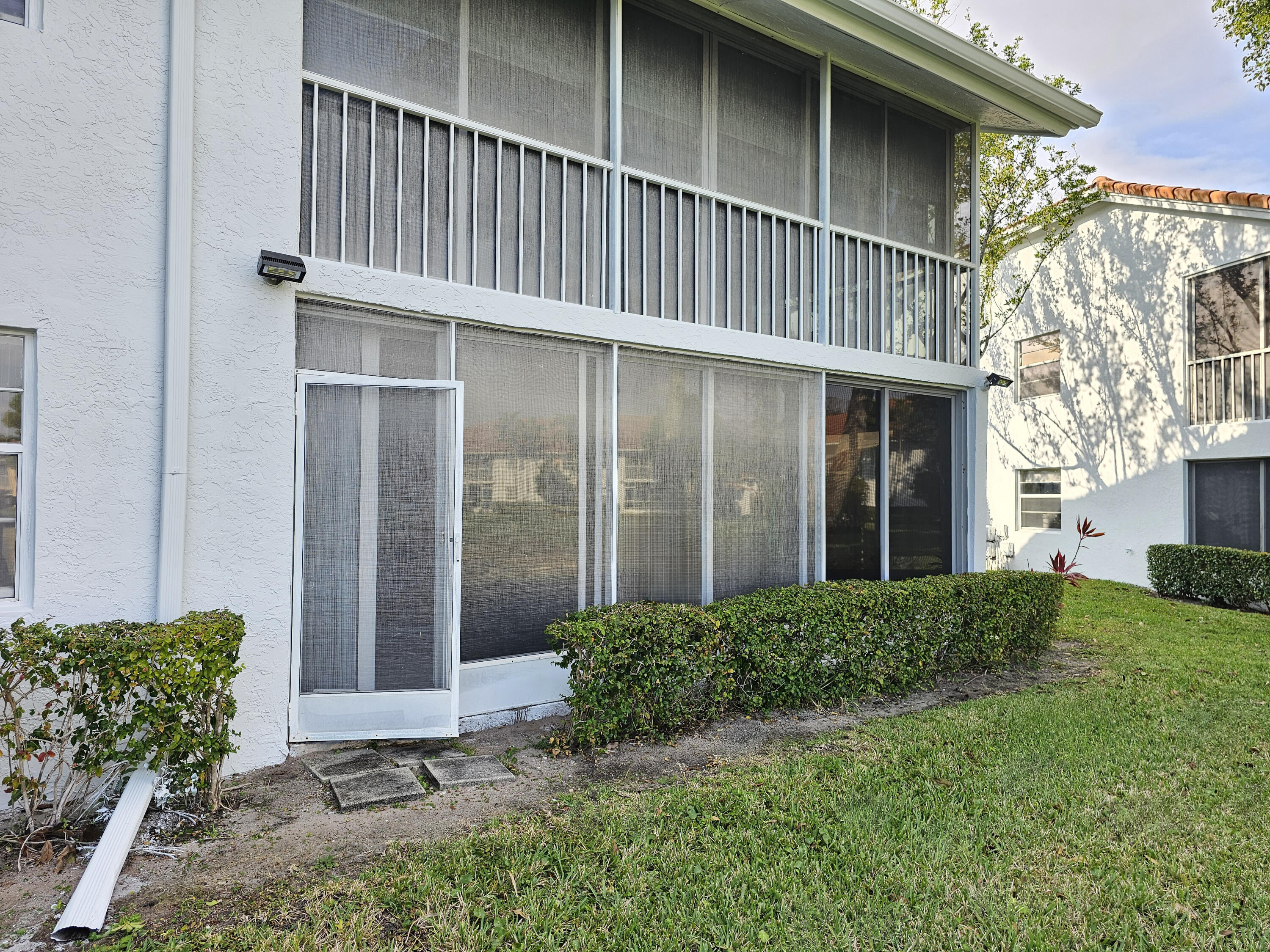 9963 Seacrest Circle, Unit 101 Boynton Beach, FL 33437 - Photo 26 of 27 a backyard of a house with lots of green space