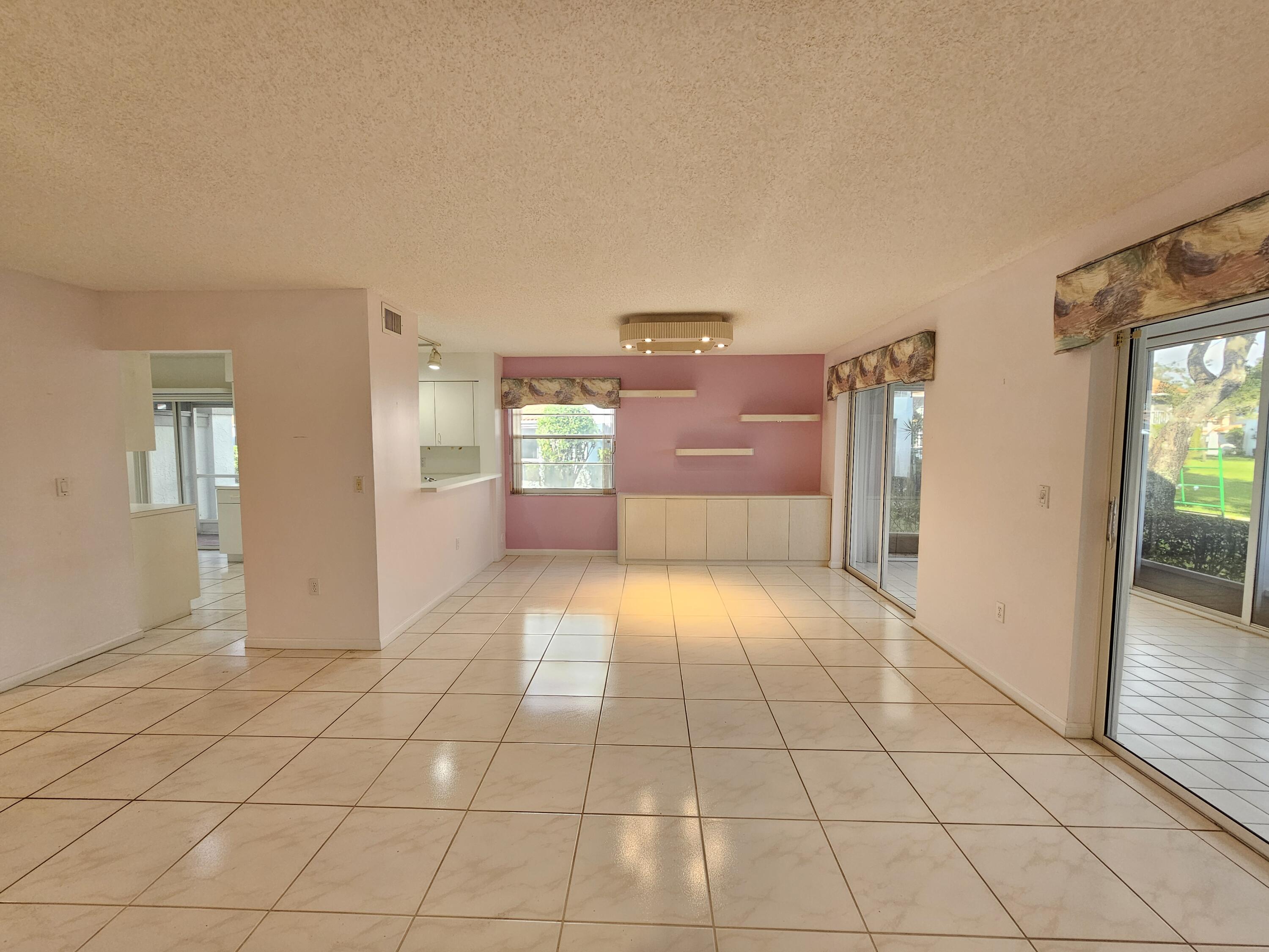 9963 Seacrest Circle, Unit 101 Boynton Beach, FL 33437 - Photo 7 of 27 a view of empty room with open kitchen
