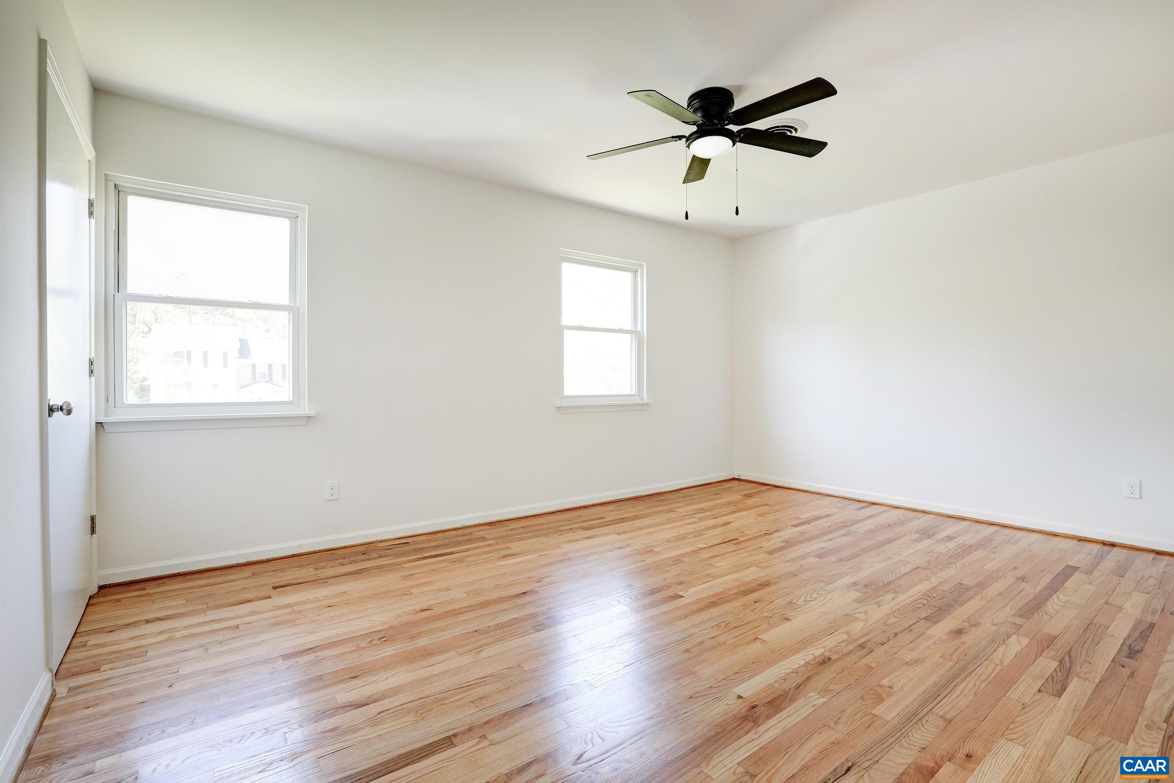 605 Bailey Road Charlottesville, VA 22903 - Photo 14 of 25 an empty room with wooden floor and windows