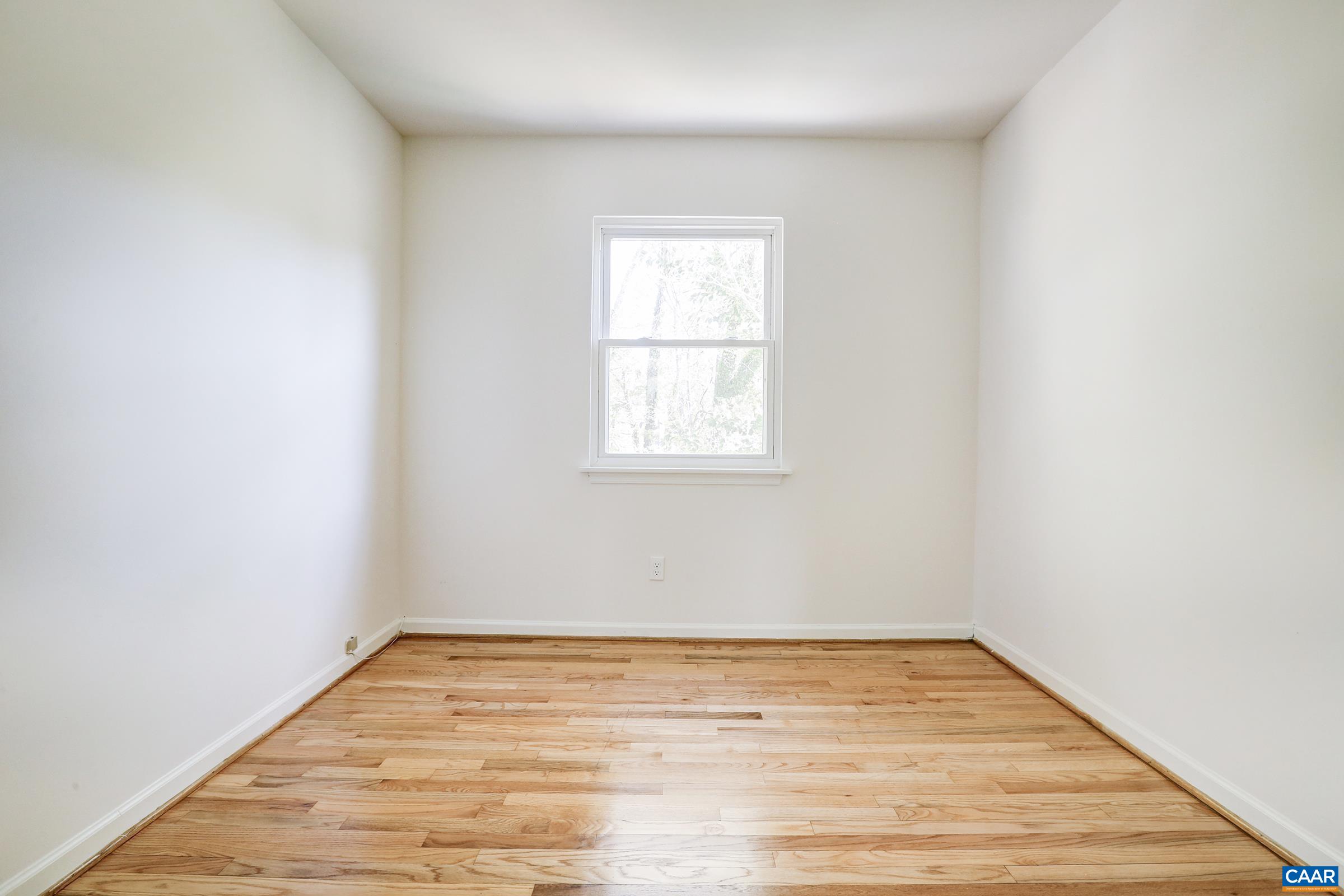 605 Bailey Road Charlottesville, VA 22903 - Photo 19 of 25 an empty room with wooden floor and windows