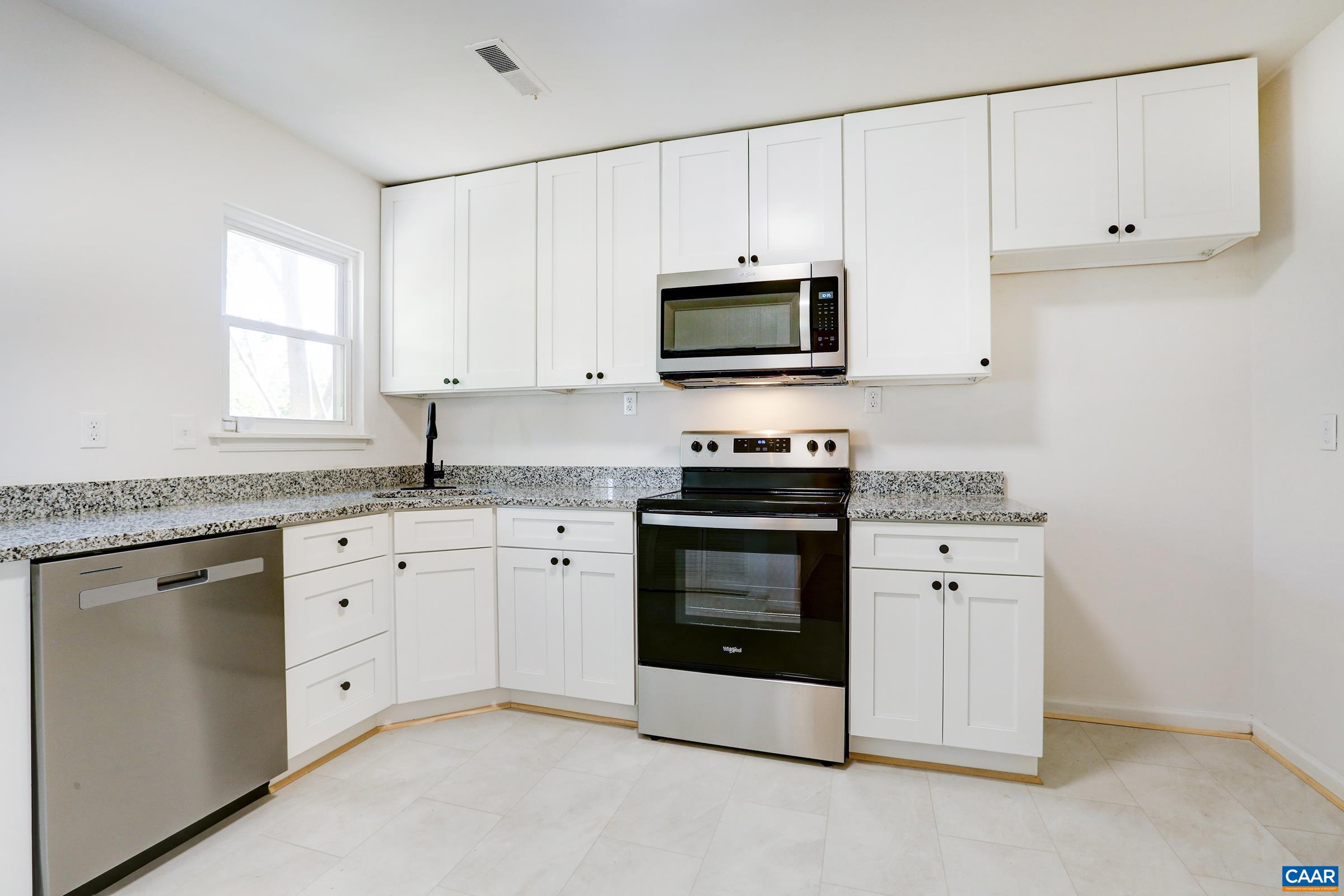 605 Bailey Road Charlottesville, VA 22903 - Photo 9 of 25 a kitchen with granite countertop white cabinets white stainless steel appliances and a sink