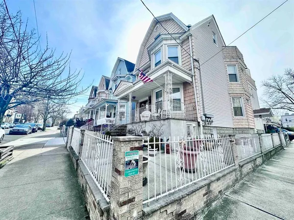 a view of multiple houses with a small yard