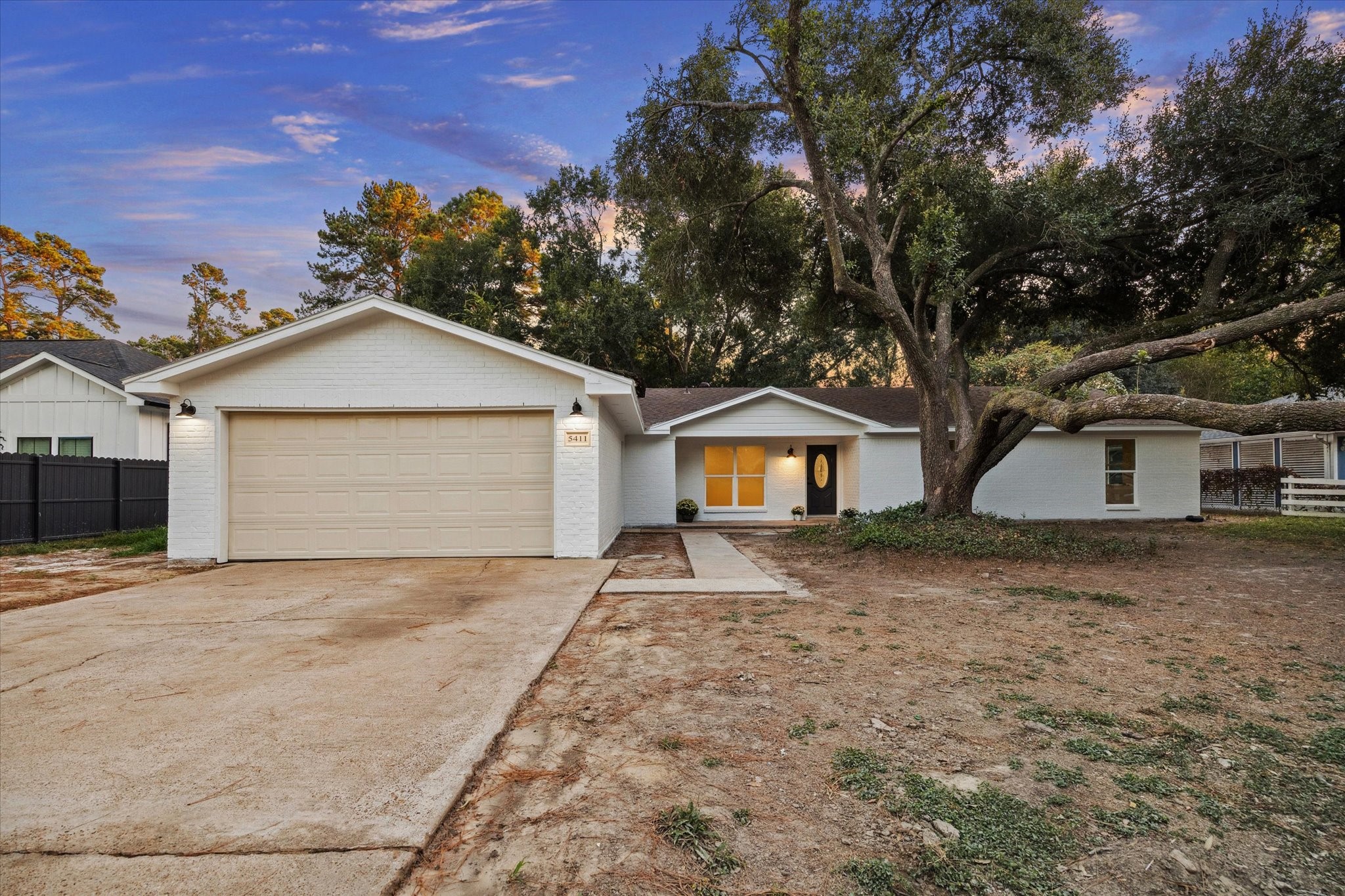 5411 Logston Lane Spring, TX 77389 - Photo 4 of 32 a front view of a house with a yard and garage