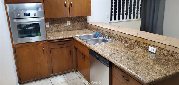 a kitchen with granite countertop a sink and stove