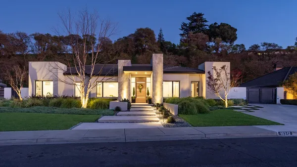 a front view of a house with garden