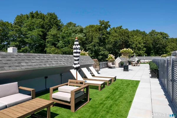 a view of a patio with chairs and a table