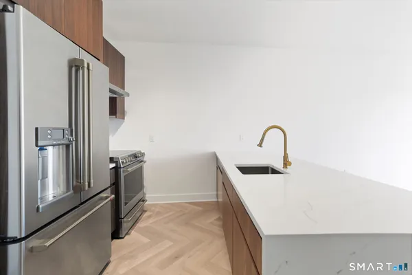 a kitchen with a refrigerator and a sink