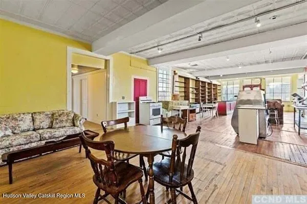 a dining room with furniture and wooden floor