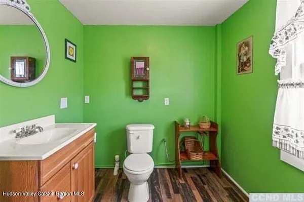 a bathroom with a toilet sink and mirror