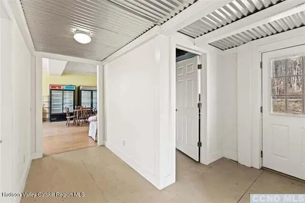 a view of a livingroom with furniture and a hallway