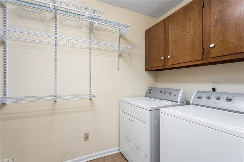 4849 Tower Road, Unit F Greensboro, NC 27410 - Photo 11 of 24 Large Laundry Room adjacent to the kitchen provides additional storage space. There is additional storage space in an outdoor storage room off the patio