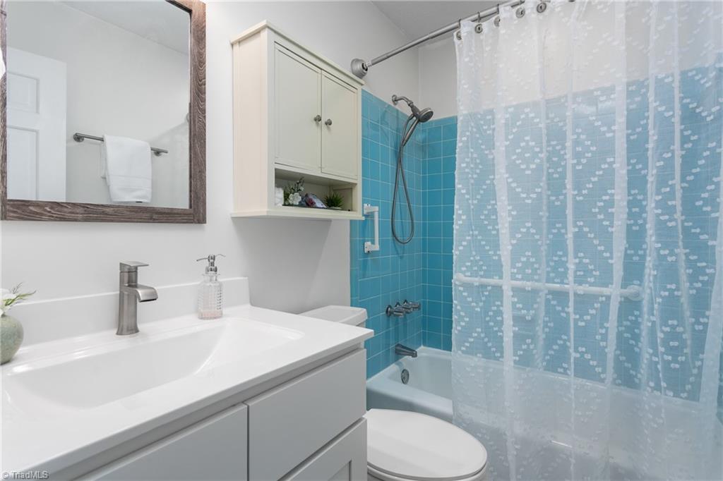 4849 Tower Road, Unit F Greensboro, NC 27410 - Photo 15 of 24 Primary Bath with new vanity, countertop, fixtures, mirrors and lighting