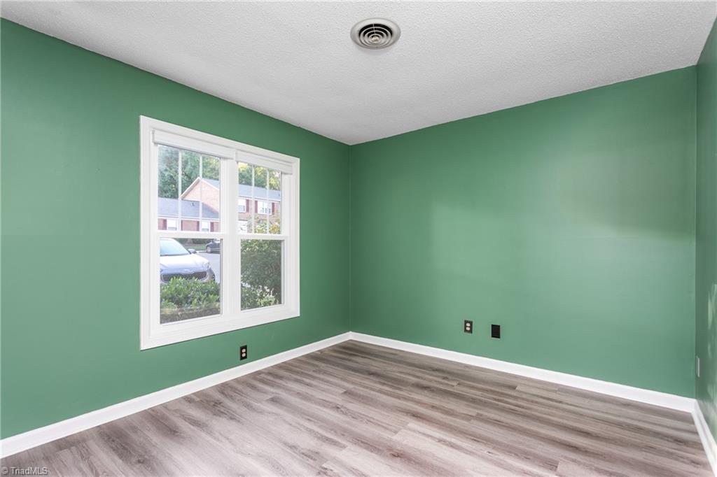 4849 Tower Road, Unit F Greensboro, NC 27410 - Photo 16 of 24 Second BR was painted and new LV flooring installed in 2021
