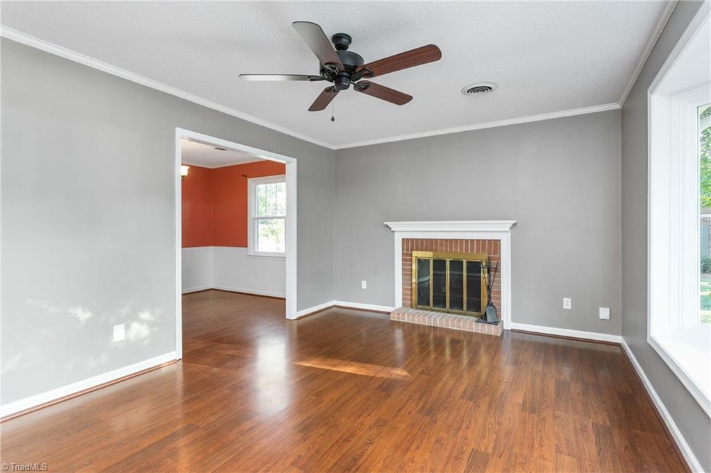 4849 Tower Road, Unit F Greensboro, NC 27410 - Photo 2 of 24 Spacious living room with FP, recently painted and LV flooring.