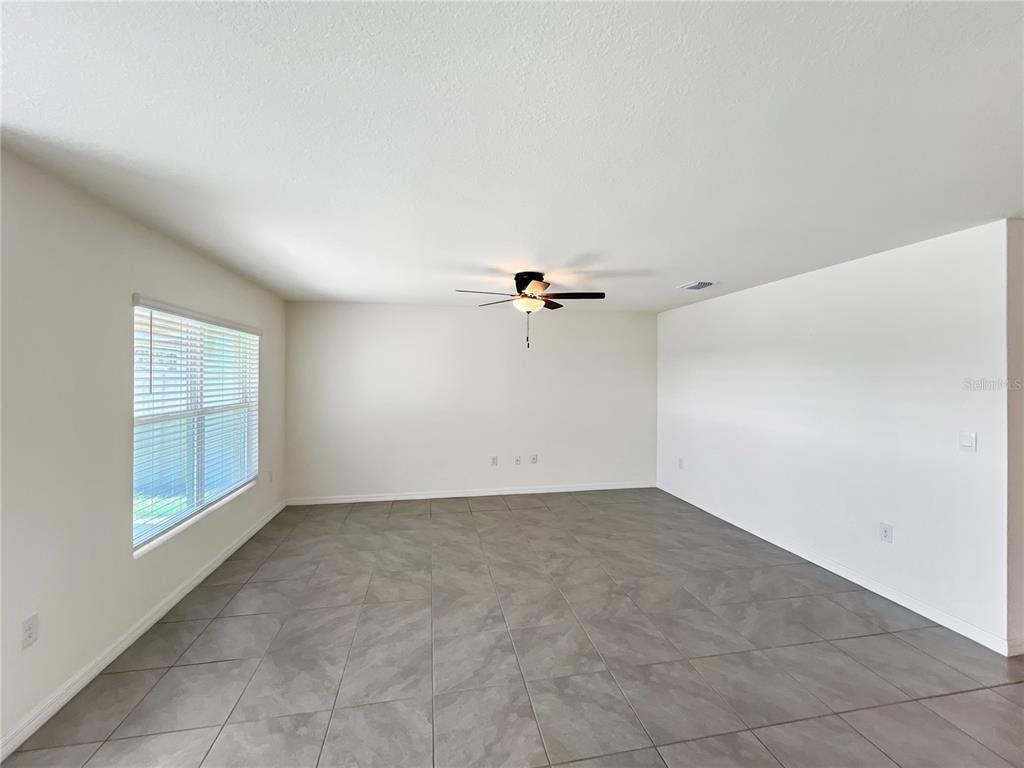 5563 Southwest 43rd Court Ocala, FL 34474 - Photo 14 of 51 an empty room with windows and fan