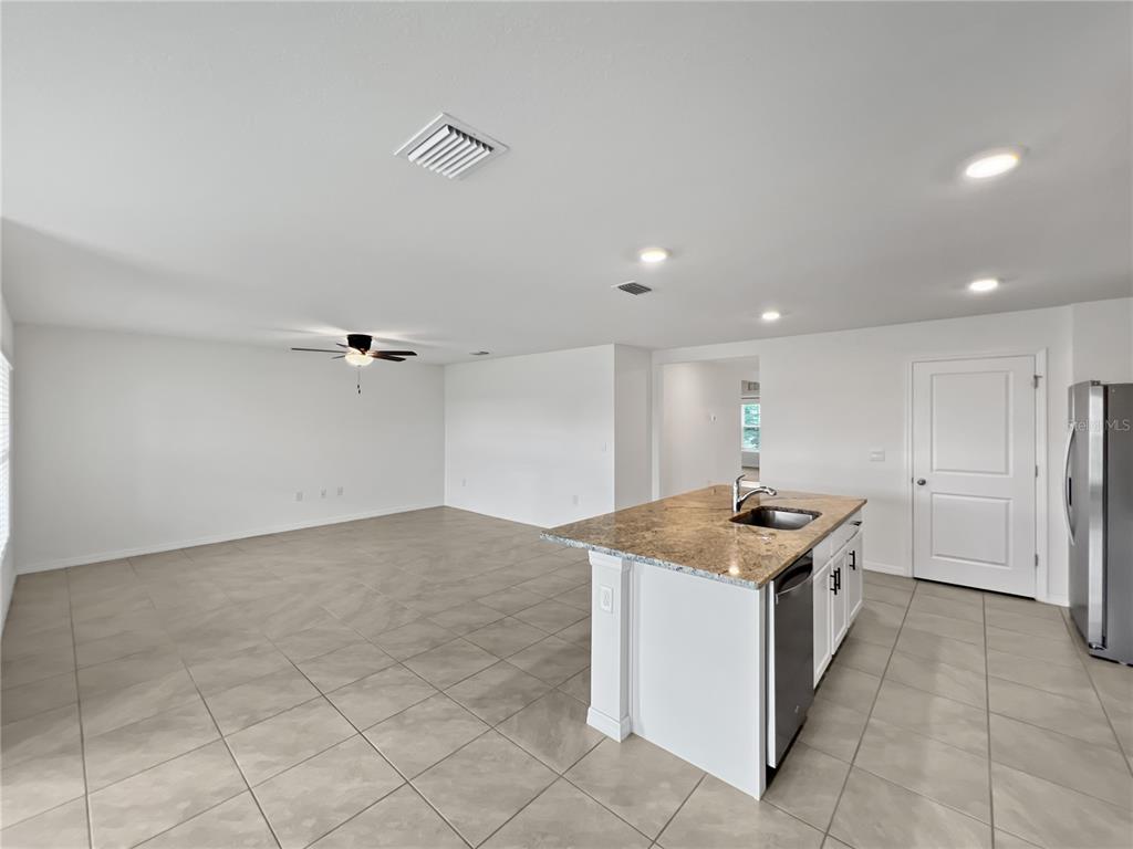 5563 Southwest 43rd Court Ocala, FL 34474 - Photo 15 of 51 a kitchen with stainless steel appliances granite countertop a sink stove and cabinets