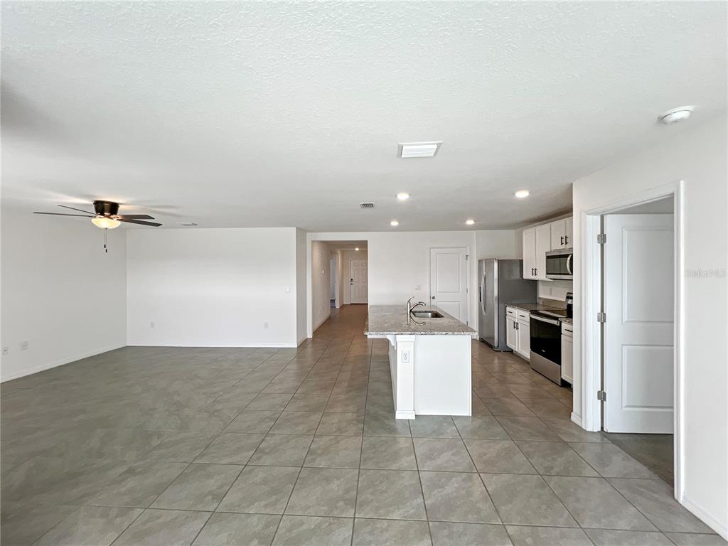 5563 Southwest 43rd Court Ocala, FL 34474 - Photo 21 of 51 a view of a kitchen with a sink and refrigerator