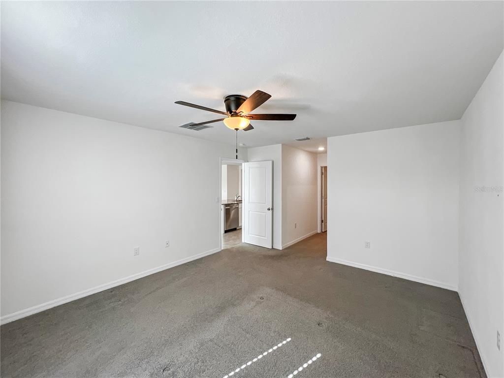 5563 Southwest 43rd Court Ocala, FL 34474 - Photo 22 of 51 a very nice looking room with a ceiling fan