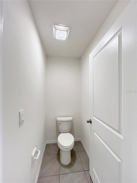 5563 Southwest 43rd Court Ocala, FL 34474 - Photo 30 of 51 a white toilet sitting next to a bathroom sink