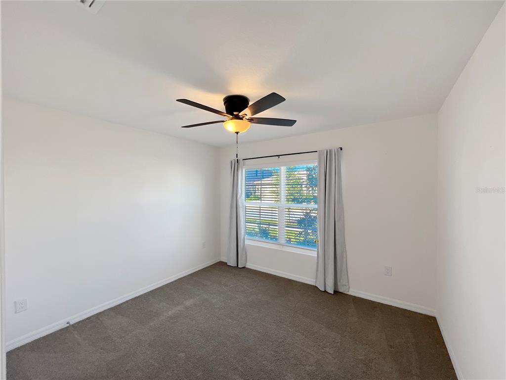 5563 Southwest 43rd Court Ocala, FL 34474 - Photo 32 of 51 a view of room with window and ceiling fan