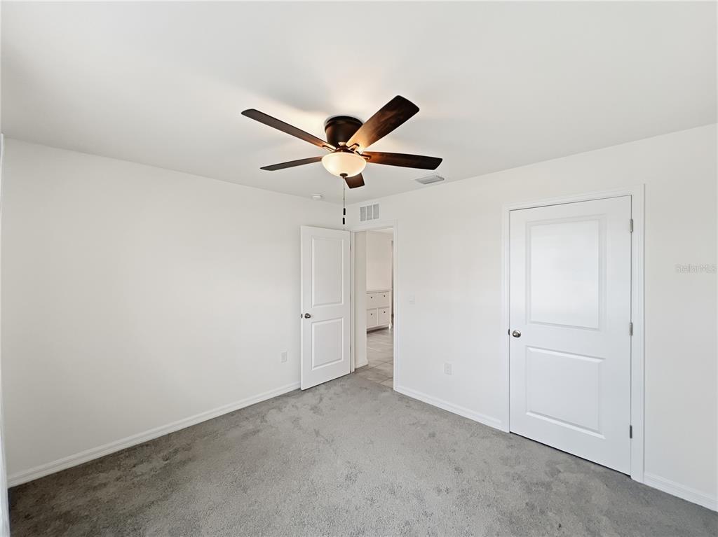 5563 Southwest 43rd Court Ocala, FL 34474 - Photo 33 of 51 an empty room with ceiling fan