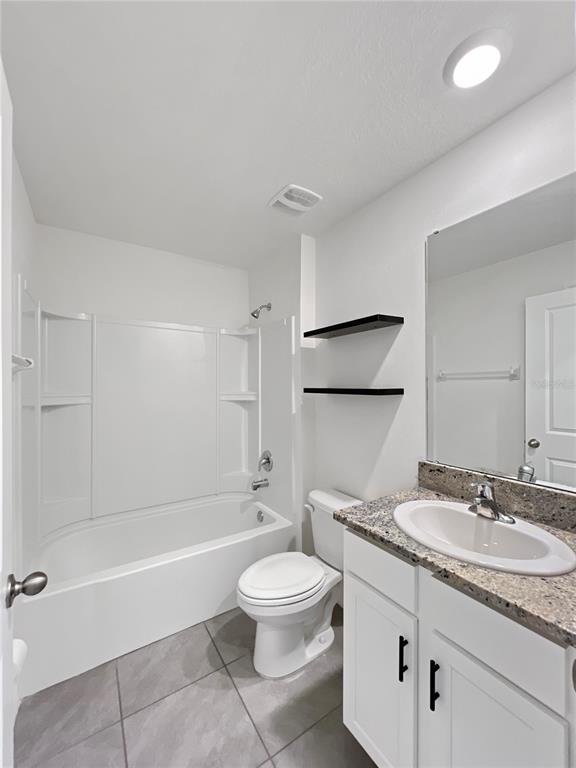 5563 Southwest 43rd Court Ocala, FL 34474 - Photo 34 of 51 a bathroom with a granite countertop sink toilet a mirror and bathtub