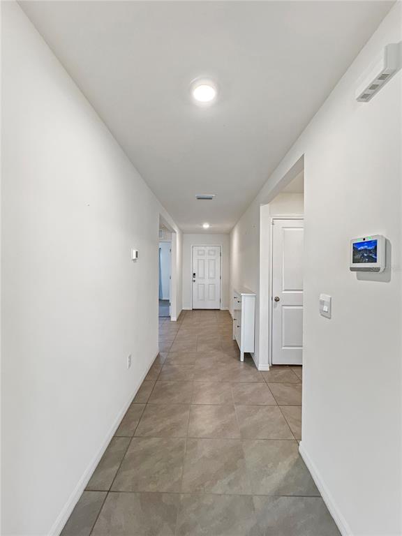 5563 Southwest 43rd Court Ocala, FL 34474 - Photo 10 of 51 an empty room with a cabinet and mirrors