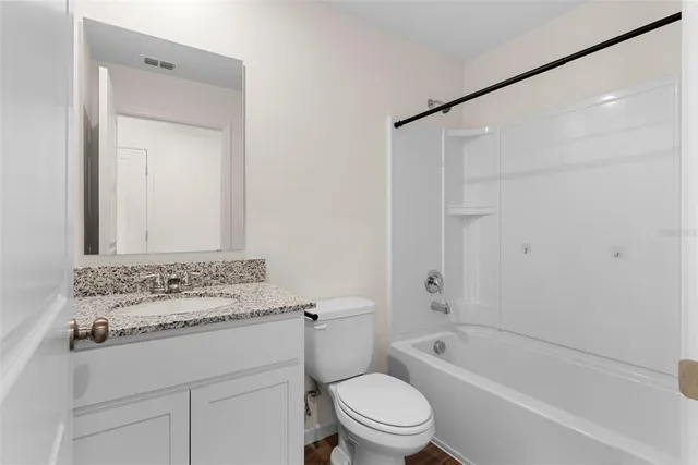 a bathroom with a sink toilet vanity and shower