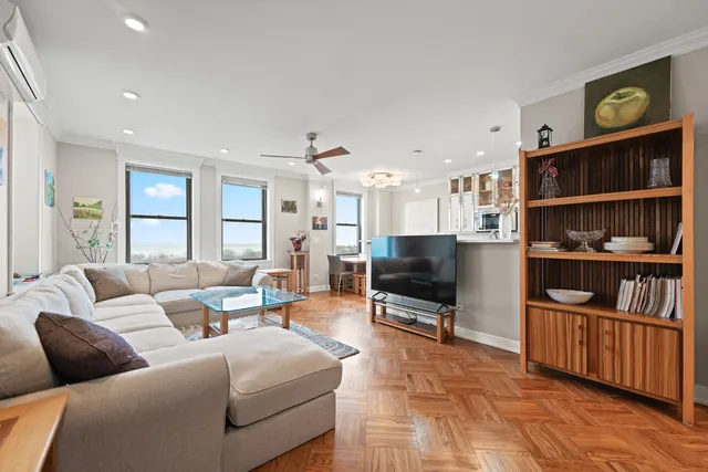 a living room with furniture and a book shelf